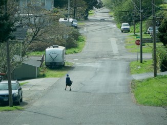 A student walks home from Millicoma School in Coos Bay.