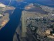 Aerial view of the Port of Coos Bay, with housing developments and an airplane strip near the Coos Bay bridge.